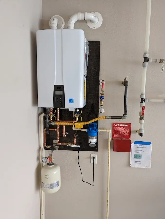 Professional plumber installing copper piping in a Catoosa home